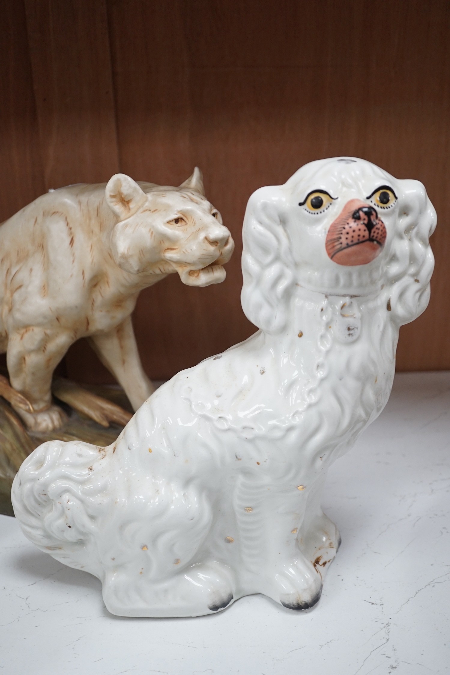 A Royal Dux tiger, a pair of Staffordshire Spaniels and a figural flat back, tiger 48 cms high
